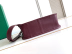 Maroon Goyard bag with pebbled leather exterior and top zipper strip detail