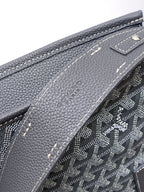 Goyard monogram bag close-up of textured leather trim and stitched side, dark gray