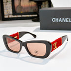 Black sunglasses with red fabric temples and gold logo detail
