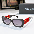 Black sunglasses with red fabric temples and gold logo detail