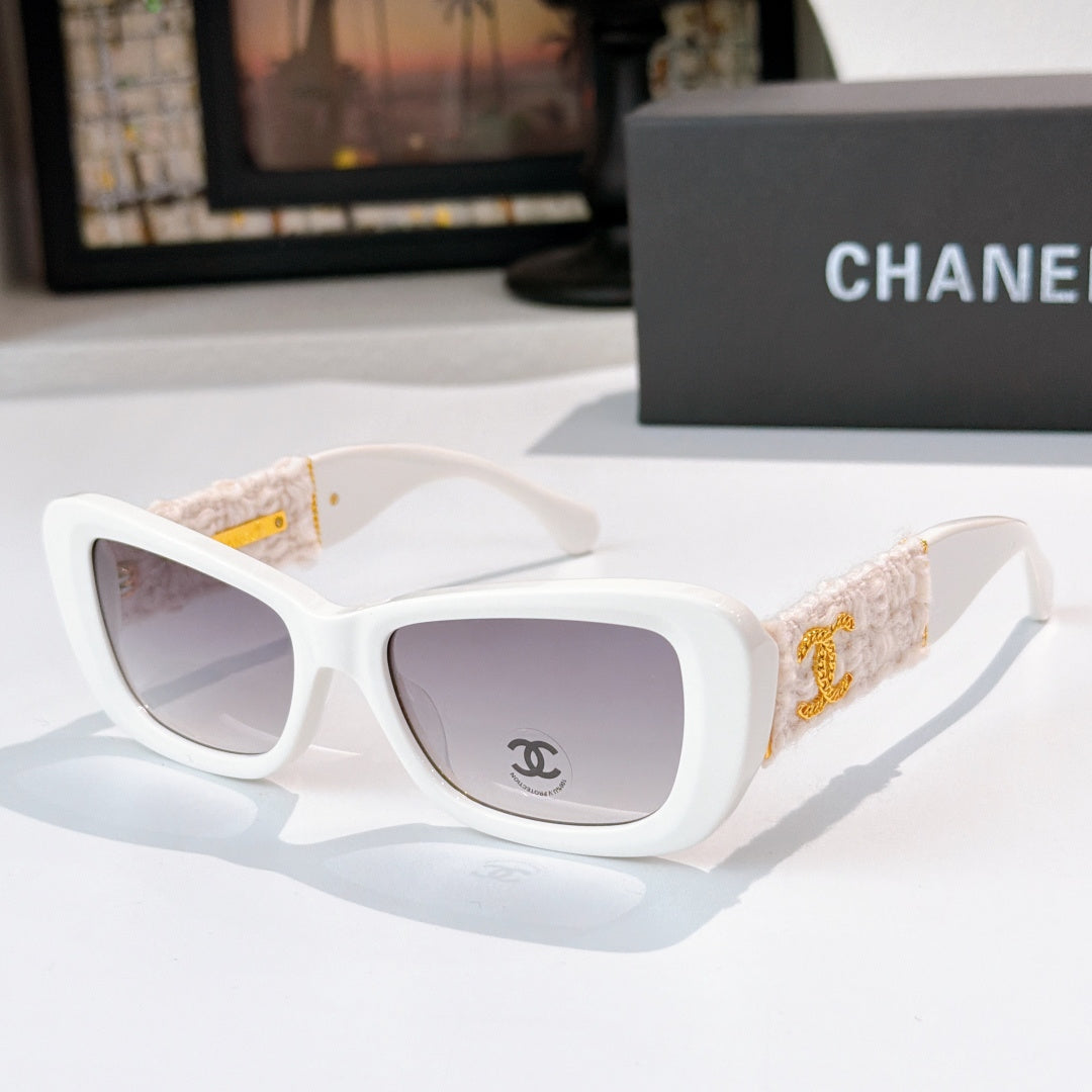 White sunglasses with beige fabric temples and gold logo detail