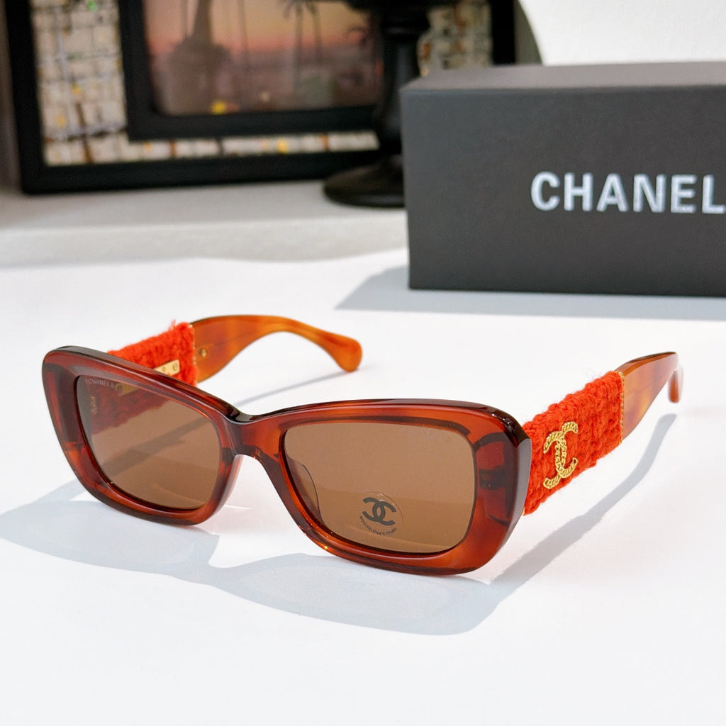 Orange tortoise sunglasses with red fabric temples and gold logo detail