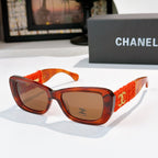 Orange tortoise sunglasses with red fabric temples and gold logo detail