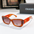 Orange tortoise sunglasses with red fabric temples and gold logo detail