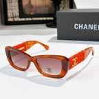 Orange tortoise sunglasses with red fabric temples and gold logo detail