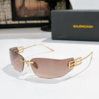 Shield sunglasses with gold frames and pink-beige tinted lenses, front view