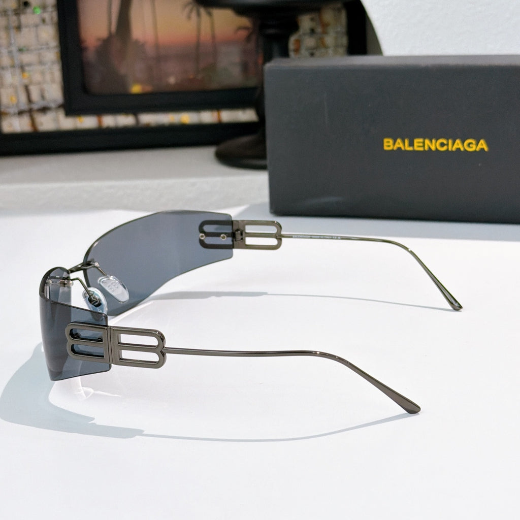 Oversized shield sunglasses with dark frames and blue-gray tinted lenses, side view