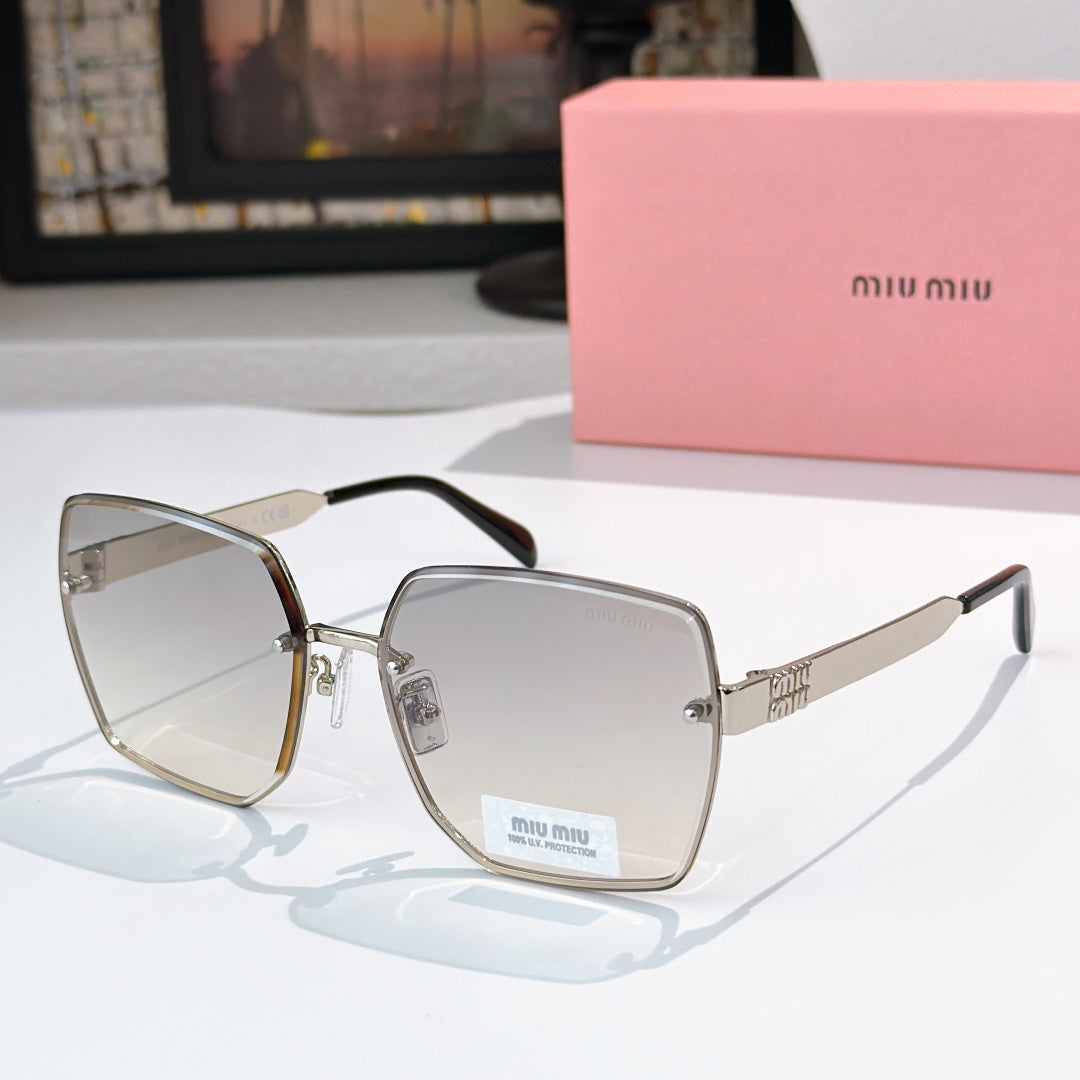 Miu Miu eyeglasses with gold-tone frames and clear lenses, black temples.