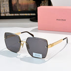 Miu Miu eyeglasses with gold-tone frames and dark gray lenses, black temples.