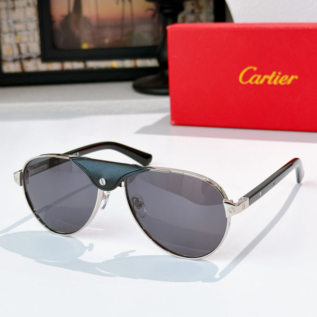 Dark teal cat-eye sunglasses with light gray gradient lenses and gold arms