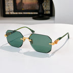 Hexagon sunglasses with gold accents and green tinted lenses in dark frame