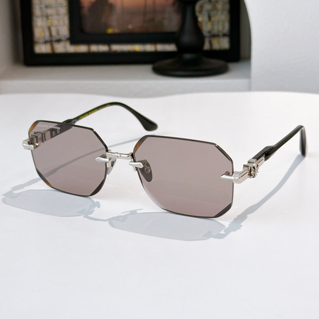 Hexagon sunglasses with silver frame, gold details, and light mauve tinted lenses