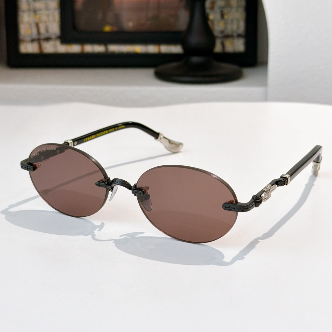 Round chrome glasses with brown tinted lenses and patterned metal temples