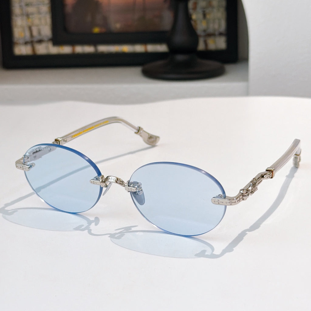 Round chrome glasses with light blue lenses and decorative metal temples