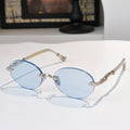 Round chrome glasses with light blue lenses and decorative metal temples