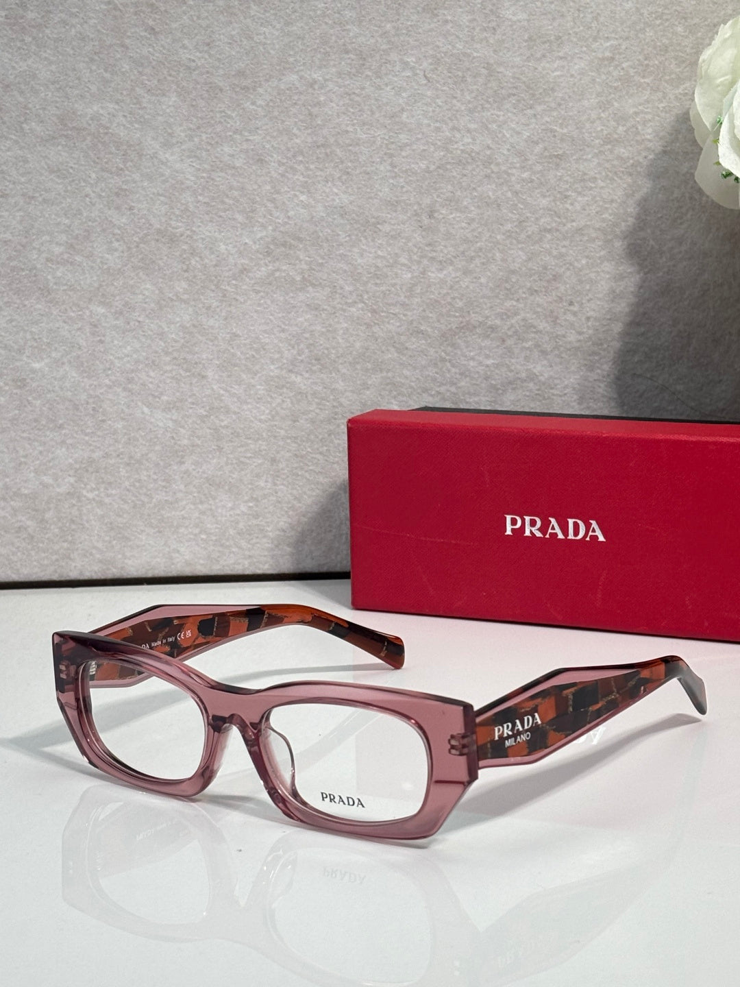 Prada eyeglasses with maroon rectangular frame and clear lenses