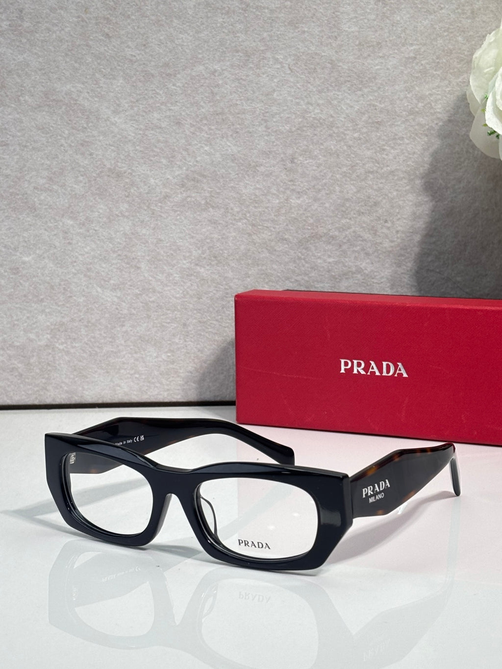Prada eyeglasses with black frame and clear lenses, PRADA on temple