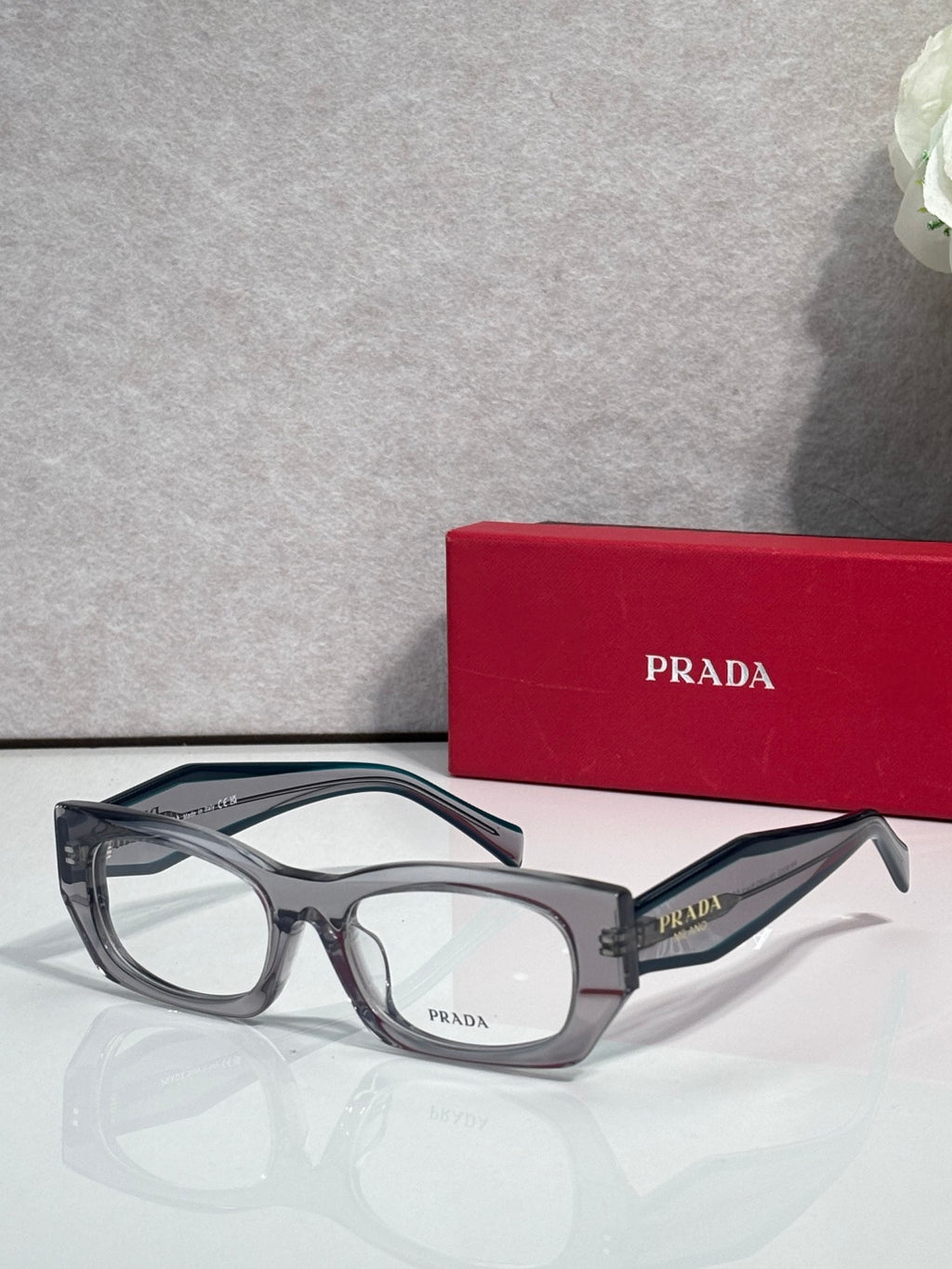 Prada eyeglasses with smoky gray rectangular frame and clear lenses
