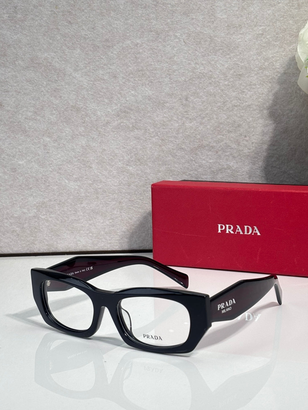 Prada eyeglasses with black rectangular frame and clear lenses
