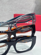 Prada eyeglasses close-up with layered black and tortoiseshell frames