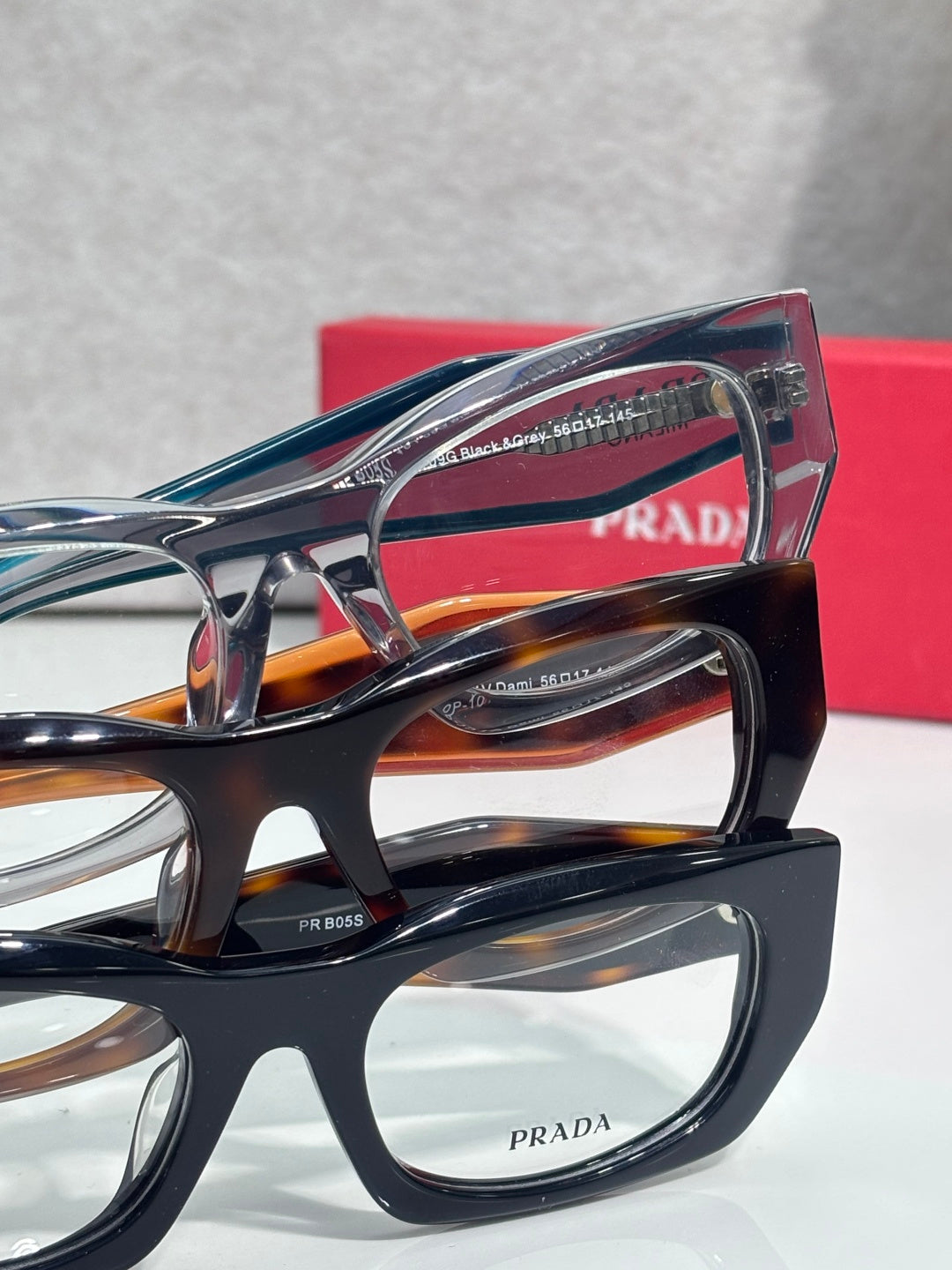 Prada eyeglasses close-up with layered black and tortoiseshell frames