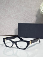 Dior eyeglass frames with matte black front, curved arms, clear lenses