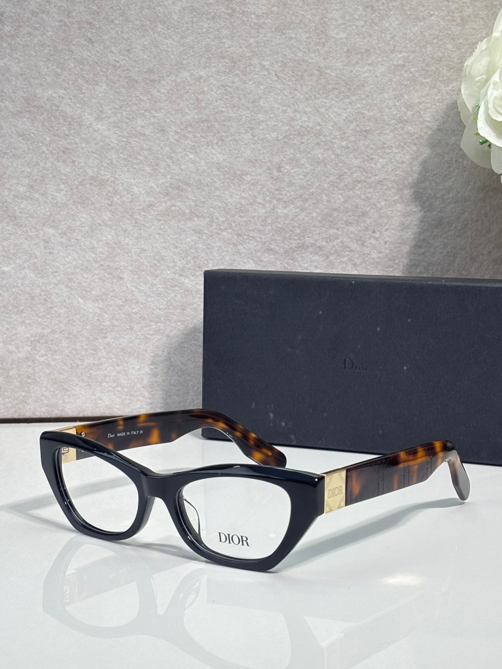 Dior eyeglass frames with dark tortoise acetate and black front, clear lenses