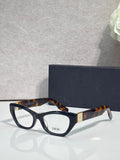 Dior eyeglass frames with dark tortoise acetate and black front, clear lenses