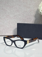Dior eyeglass frames with dark tortoise acetate and black front, clear lenses