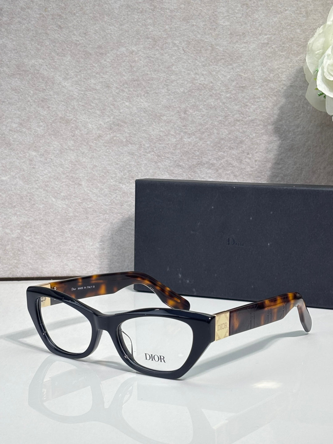 Dior eyeglass frames with dark tortoise acetate and black front, clear lenses