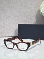 Dior eyeglass frames with warm tortoise acetate, rounded rectangular shape, clear lenses