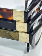 Dior logo temple detail on black-and-brown acetate eyeglass frame with gold plates