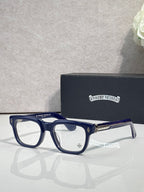Chrome glasses with dark blue acetate frames, clear lenses, gold accents on temples
