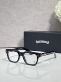 Chrome glasses with dark blue frames and clear lenses, gold temple tips