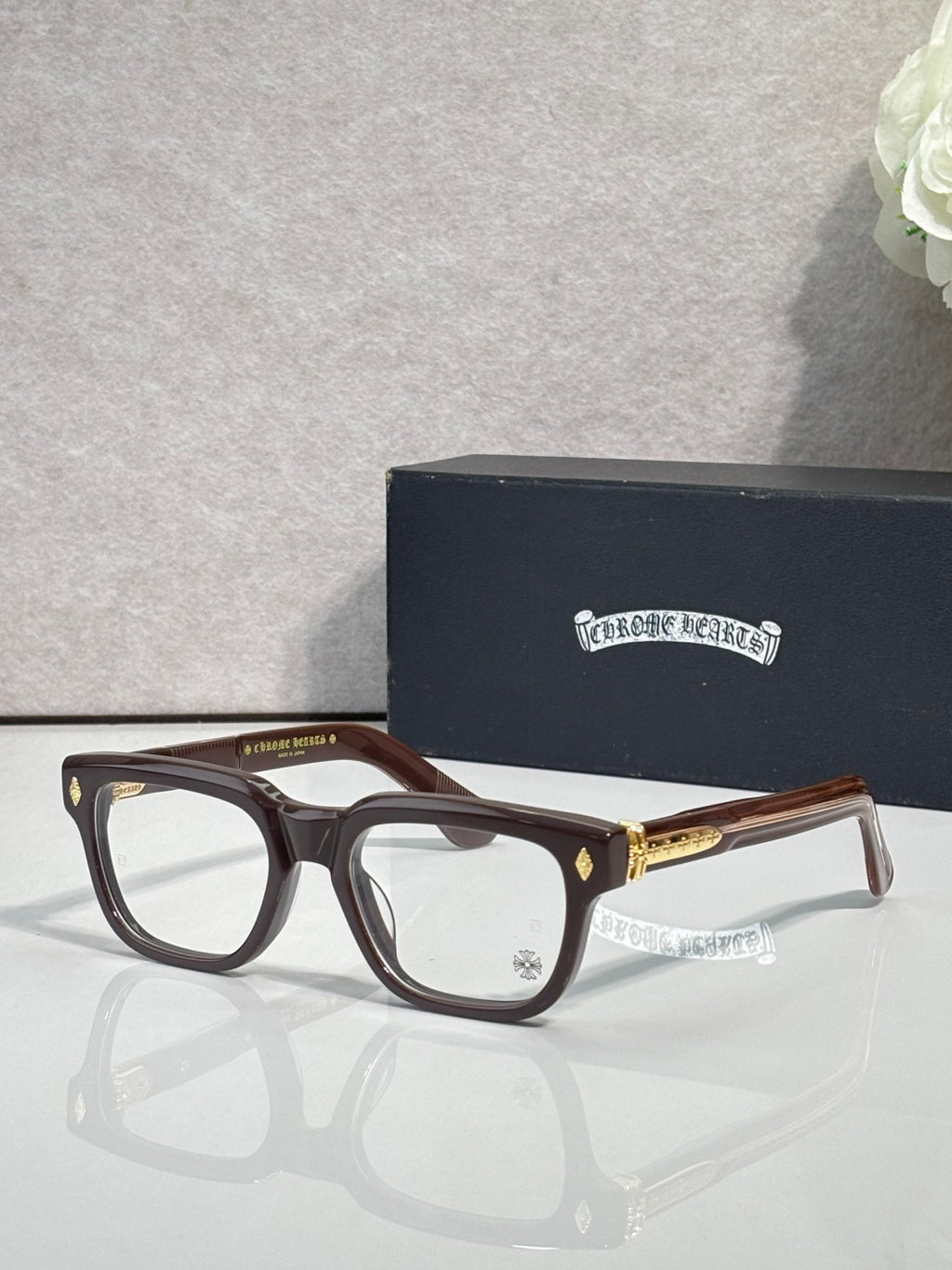 Chrome glasses with brown frames and clear lenses, gold temple accents