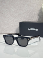 Black sunglasses with dark lenses and clear temple tips, front view