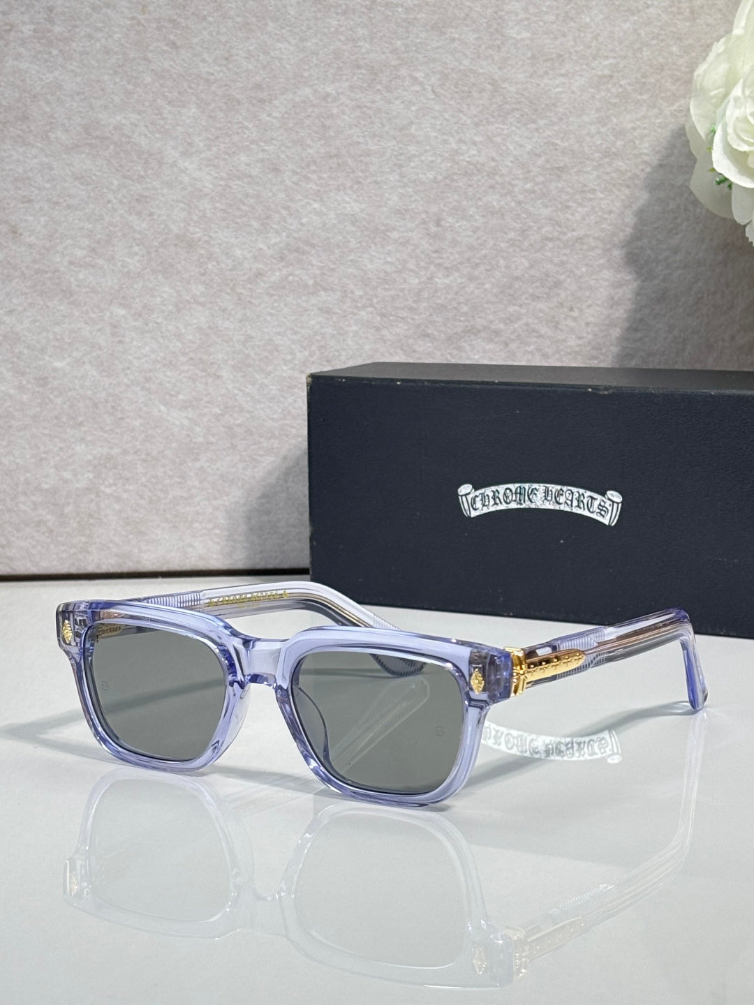 Translucent light-blue sunglasses with dark lenses and clear temple tips