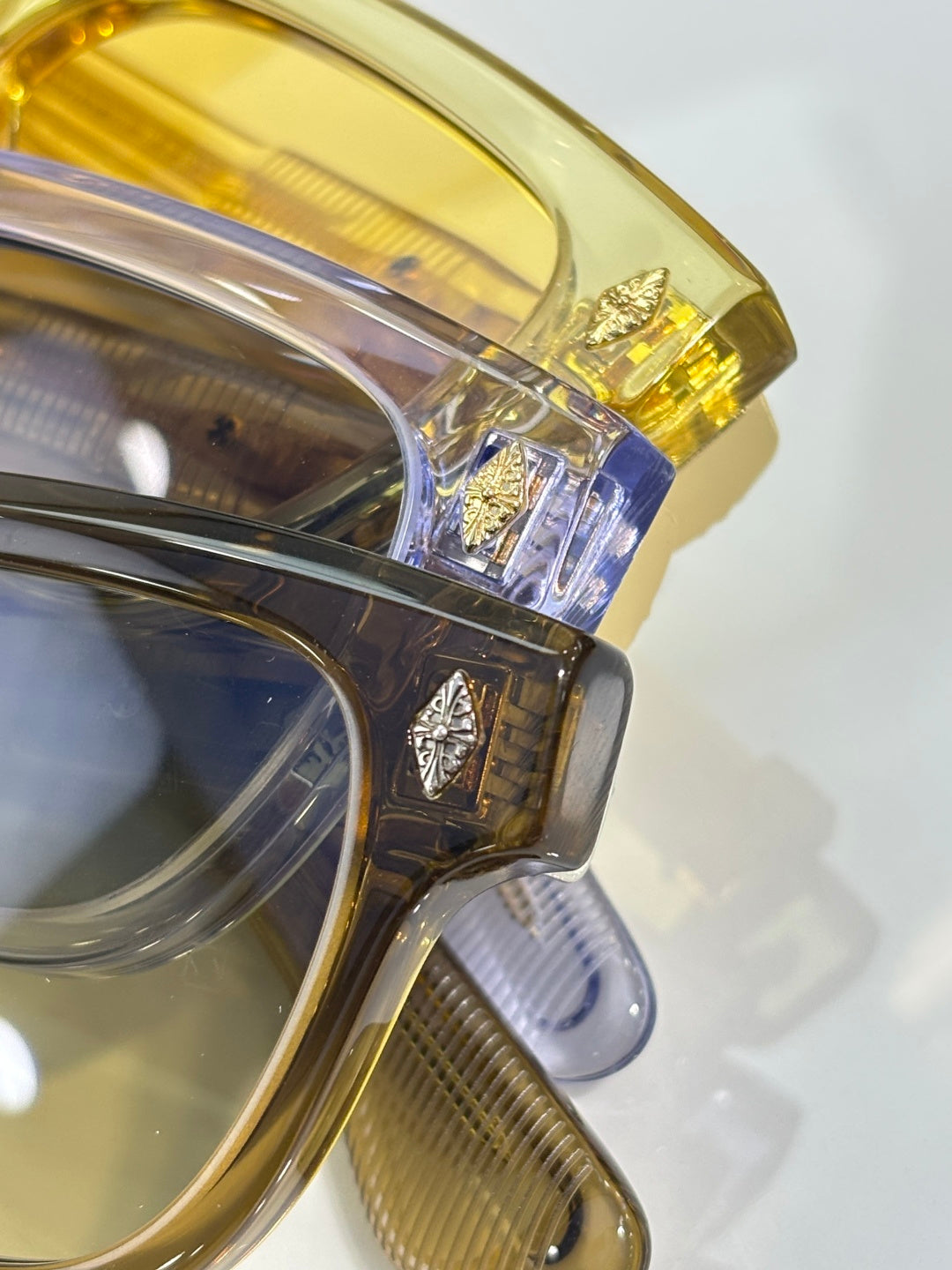 Close-up of gold and clear sunglasses frame with decorative temple detail