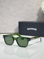 Green sunglasses with dark lenses and clear temple tips