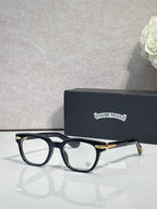 Black round eyeglasses with gold-toned temple accents and clear lenses