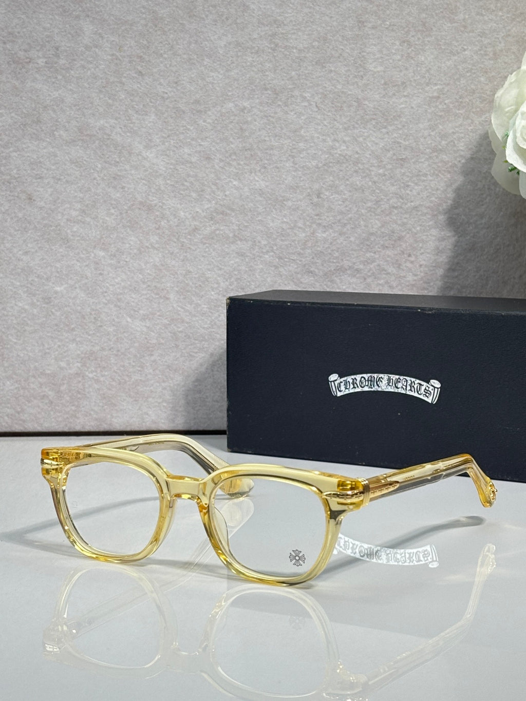 Gold round eyeglasses with dark-tinted lenses and slim metal arms