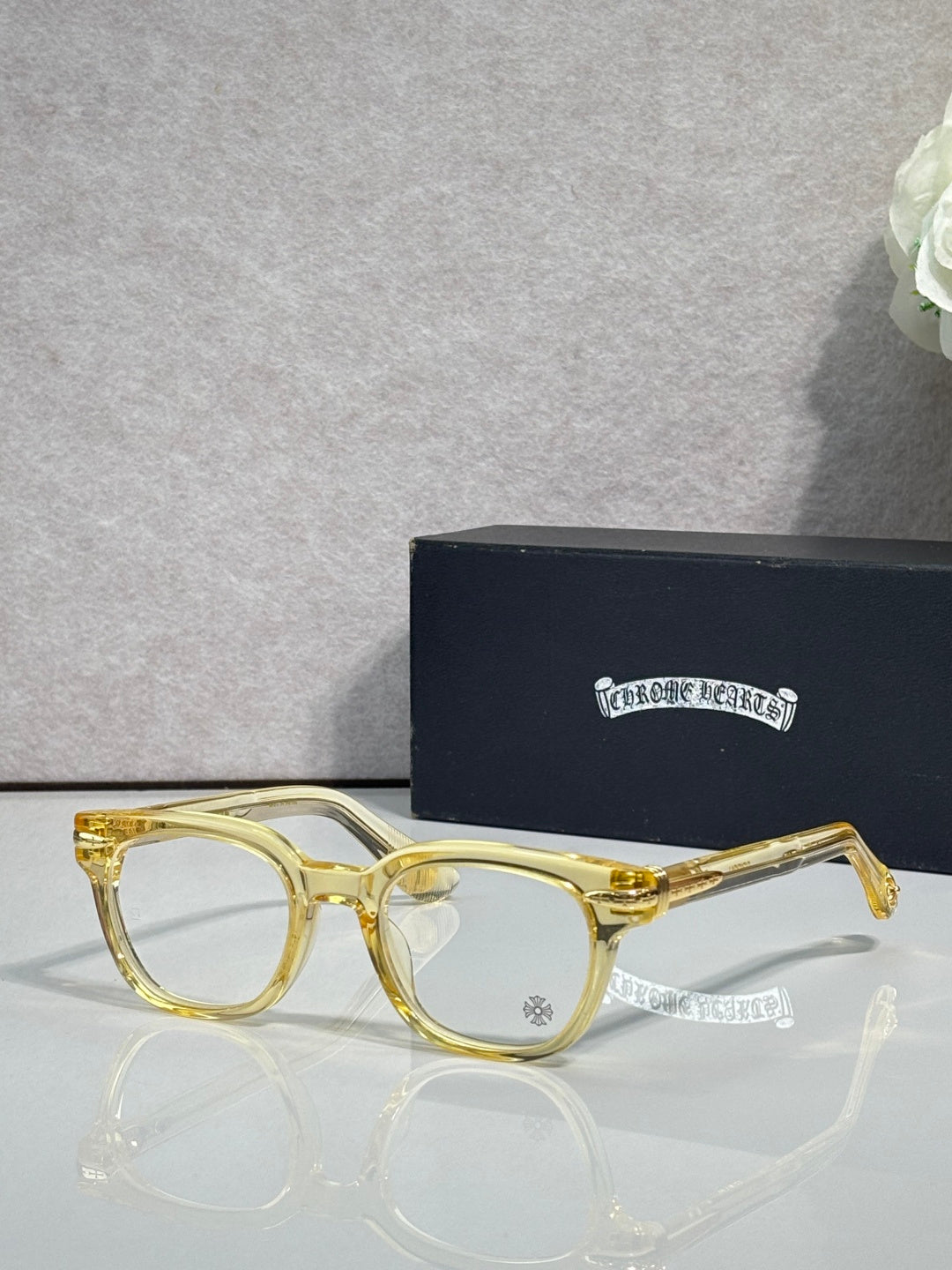 Gold round eyeglasses with dark-tinted lenses and slim metal arms