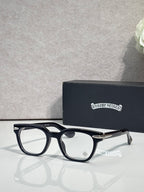 Black round eyeglasses with clear lenses and gold-toned temple tips