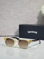 Glasses with gold frames and light brown lenses, with clear ear tips.