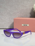 Purple cat-eye sunglasses with dark lenses and gold logo detail at temples.
