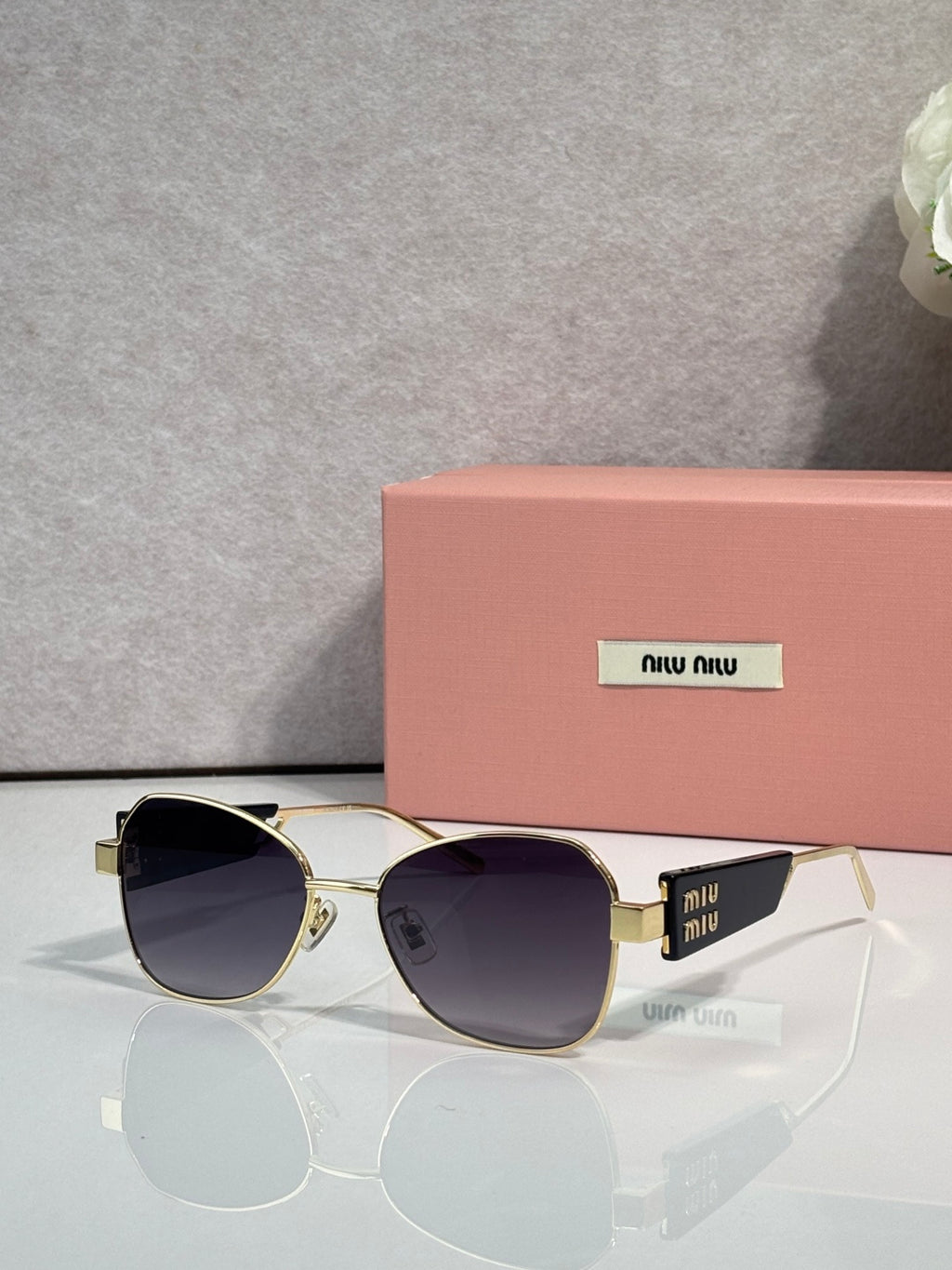 Round sunglasses with dark lenses and gold-tone metal frames