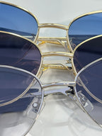Multiple round sunglasses with navy lenses and gold-silver metal frames