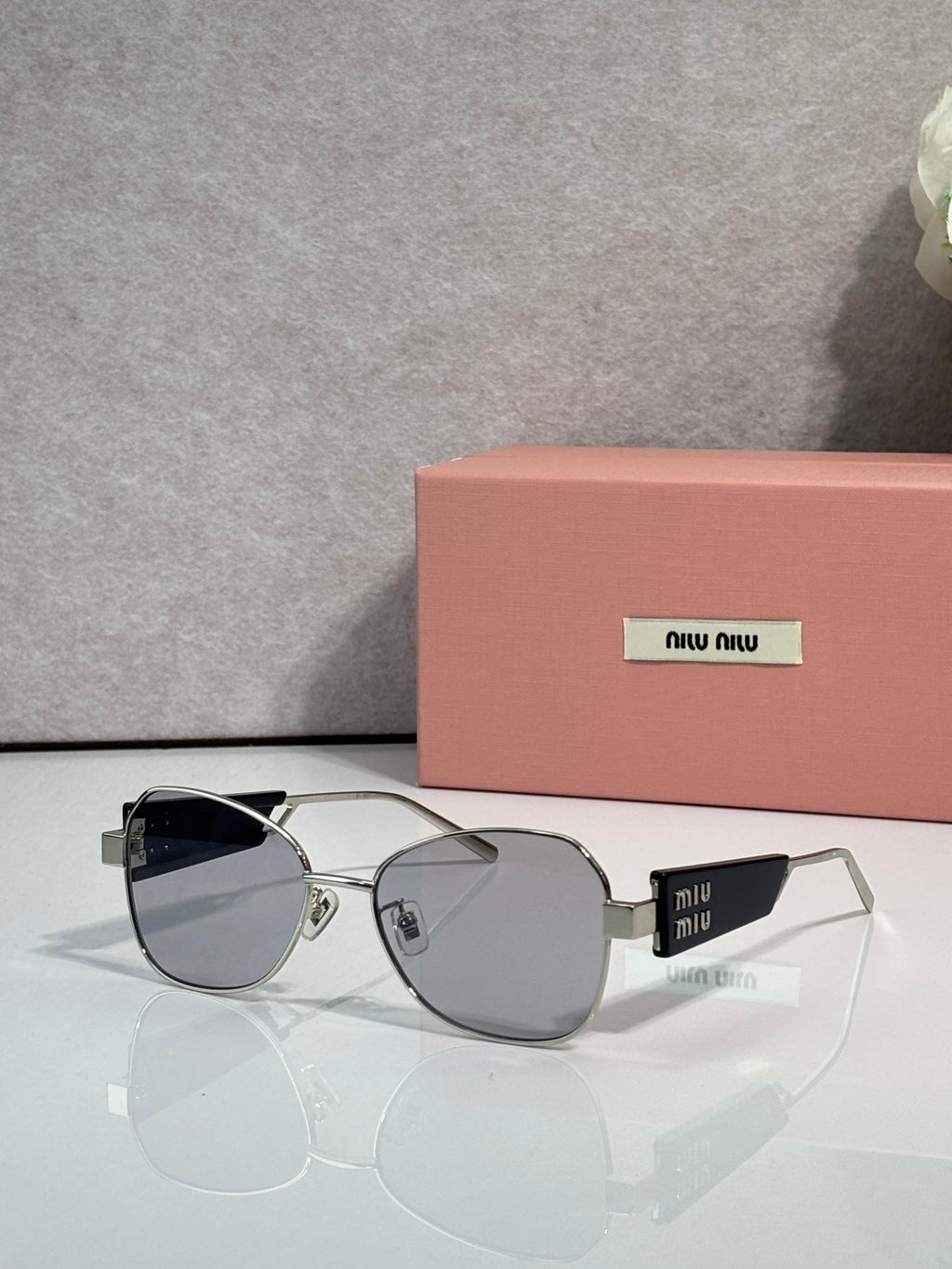 Round sunglasses with gray lenses and silver metal frames