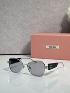 Round sunglasses with gray lenses and silver metal frames