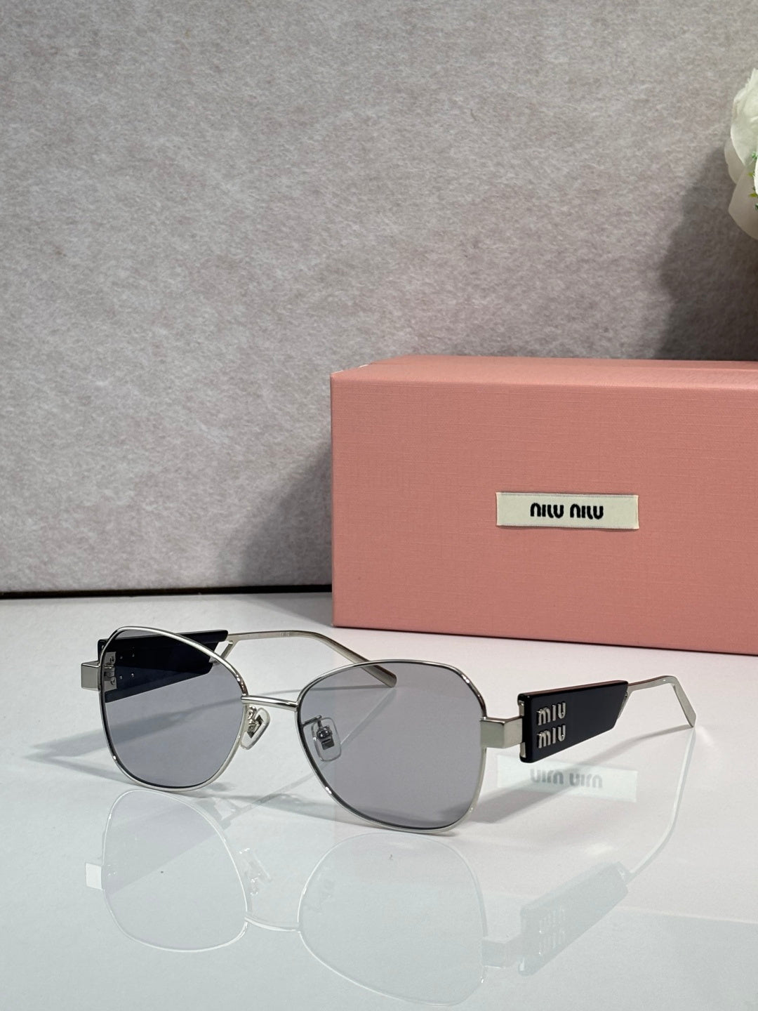Round sunglasses with gray lenses and silver metal frames